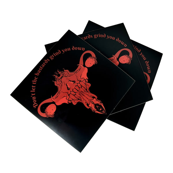 Don't Let Them Grind You Down vinyl sticker with bold red illustration on black background, square shape, glossy finish.