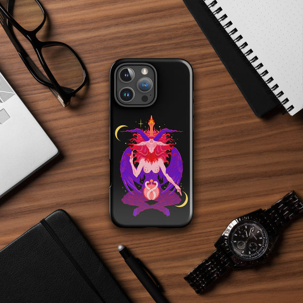 Baphomet tough iPhone case featuring vibrant original illustration on a wooden desk with accessories.