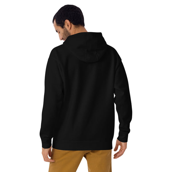 Man wearing black unisex hoodie with witchy moth illustration, showing back view and hood, paired with brown pants.