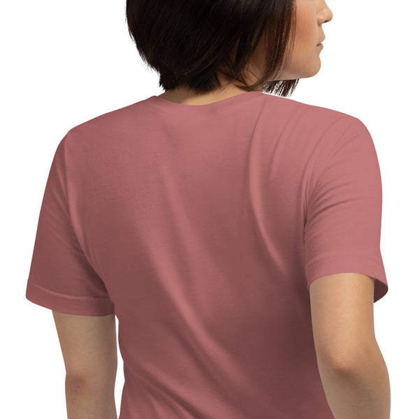 Person wearing a rose-colored unisex t-shirt, back view, showcasing soft fabric and comfortable fit.