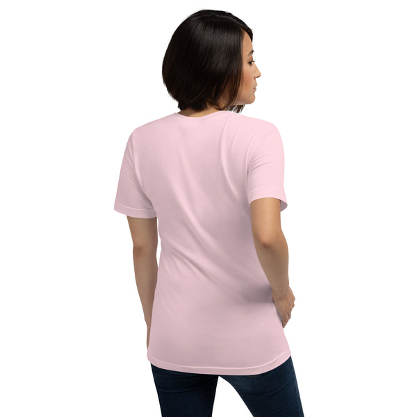 Back view of a woman wearing a pink unisex t-shirt featuring original kitsune fox artwork.