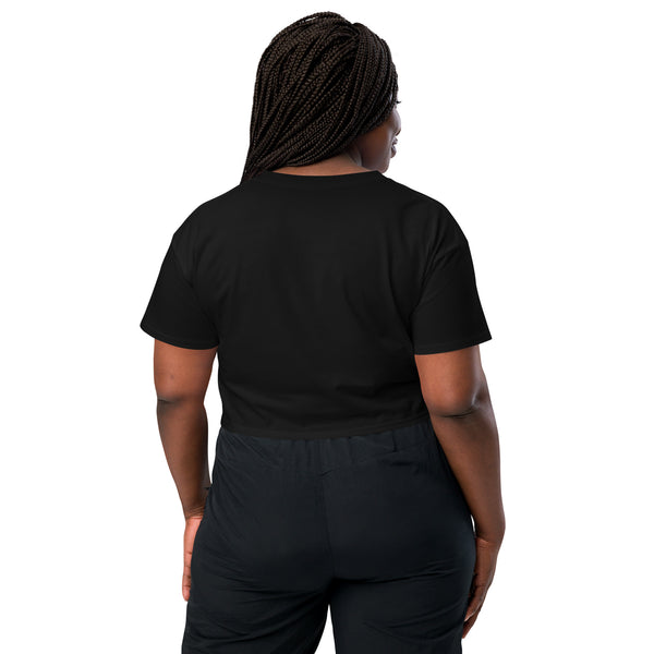 Woman wearing black cropped t-shirt with relaxed fit, shown from the back.