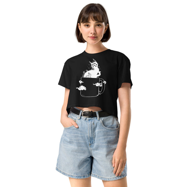 Woman wearing black crop top with creepy cute black cat in coffee cup artwork, casual relaxed fit, gothic witchy fashion.