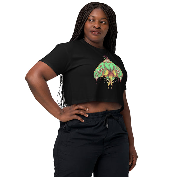 Woman wearing black relaxed crop top featuring hand drawn green luna moth artwork with many eyes, perfect for gothic or witchy aesthetic