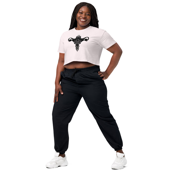 Woman wearing Death Metal Uterus relaxed crop top in white with black pants, showcasing alternate witchy aesthetic.