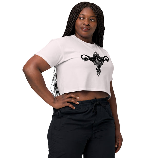 Woman wearing death metal uterus relaxed crop top with hand-drawn artwork, white crop top with black design, comfortable fit for hot days